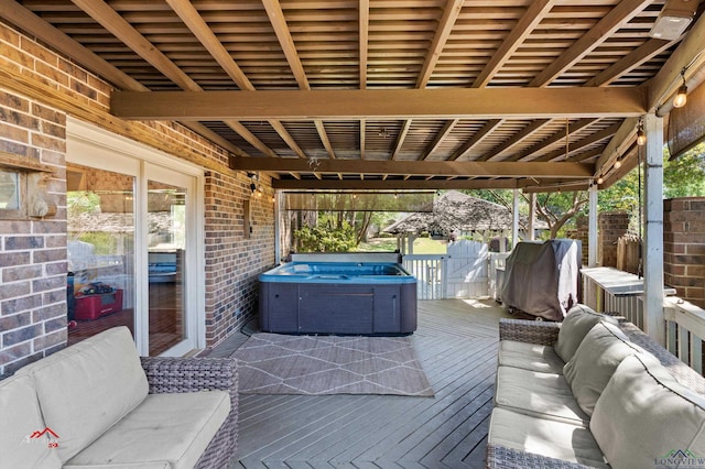 view of patio / terrace with a deck and a hot tub