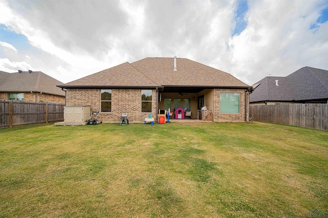 back of property featuring ceiling fan, a yard, and a patio