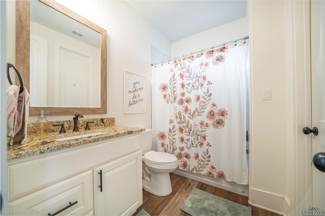 full bathroom featuring wood-type flooring, vanity, toilet, and shower / bathtub combination with curtain