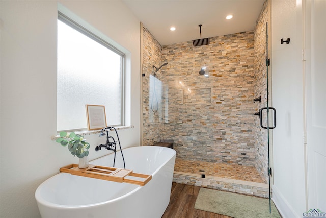 bathroom featuring hardwood / wood-style floors and independent shower and bath