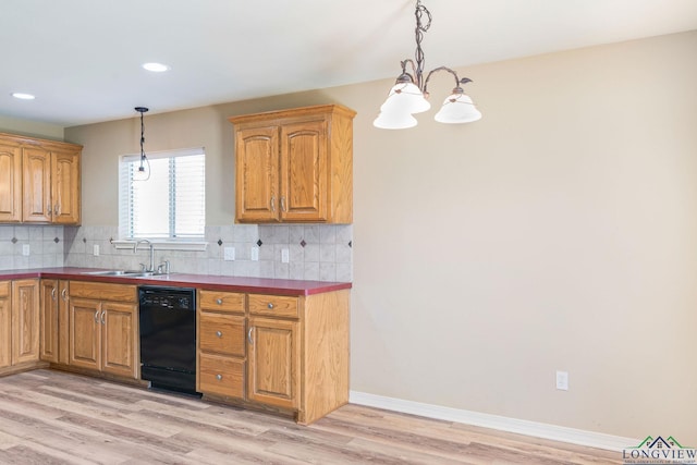 kitchen with a sink, tasteful backsplash, black dishwasher, and light wood finished floors