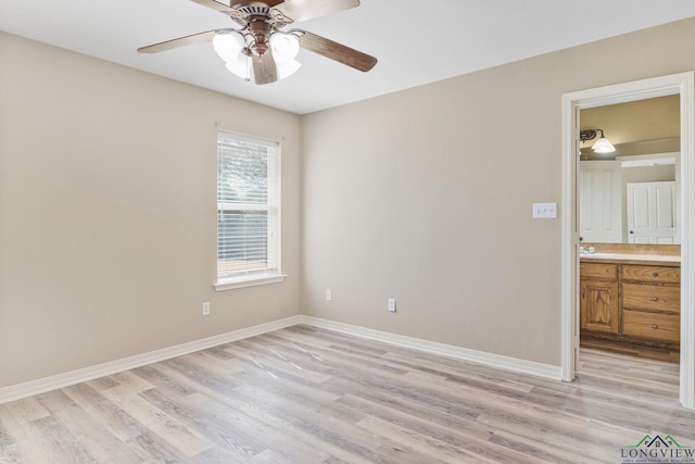 spare room with light wood-style flooring, baseboards, and ceiling fan