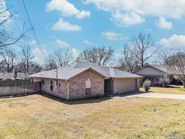 view of home's exterior with brick siding, an attached garage, a lawn, and fence