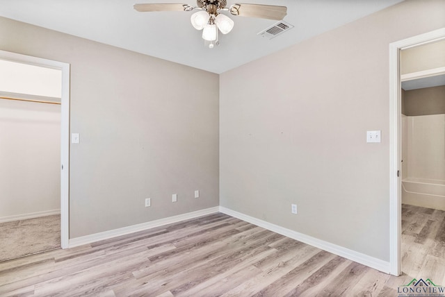 unfurnished bedroom with visible vents, a closet, light wood finished floors, baseboards, and ceiling fan