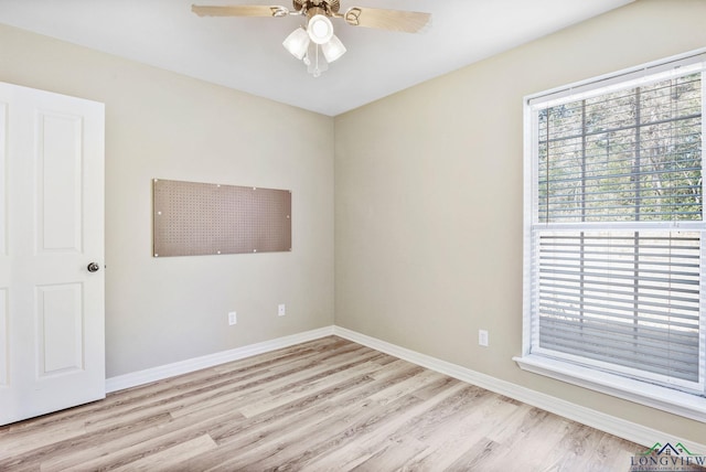 unfurnished room with ceiling fan, baseboards, and wood finished floors