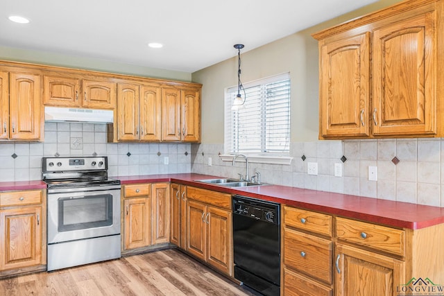 kitchen featuring under cabinet range hood, a sink, dark countertops, stainless steel range with electric cooktop, and dishwasher