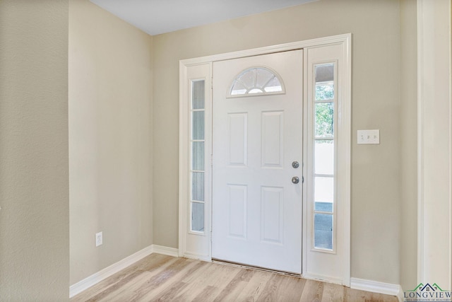 entrance foyer featuring light wood-type flooring and baseboards