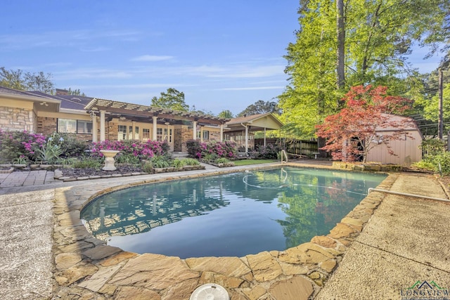 swimming pool with a pergola, an outbuilding, and a storage unit