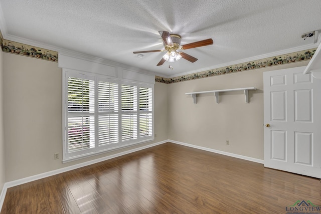 spare room featuring ceiling fan, a textured ceiling, baseboards, dark wood-style floors, and ornamental molding