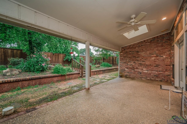 315 Tealwood Dr, Longview, TX 75605 - fenced backyard with ceiling fan and a patio area