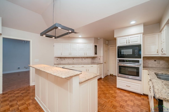 315 Tealwood Dr, Longview, TX 75605 - kitchen featuring stainless steel oven, black microwave, recessed lighting, a center island, and white cabinets