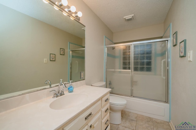 315 Tealwood Dr, Longview, TX 75605 - full bathroom featuring vanity, tile patterned floors, enclosed tub / shower combo, and a textured ceiling