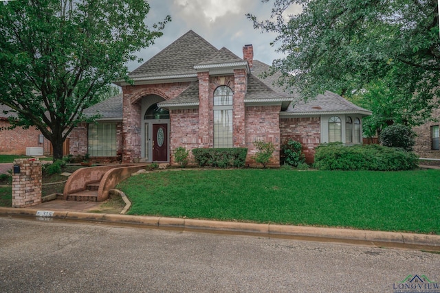 315 Tealwood Dr, Longview, TX 75605 - view of front of house with a chimney, a front lawn, a shingled roof, and brick siding