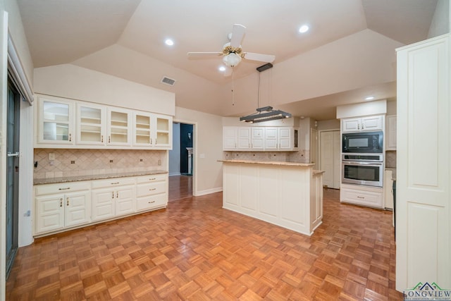 315 Tealwood Dr, Longview, TX 75605 - kitchen with oven, black microwave, tasteful backsplash, white cabinets, and a ceiling fan