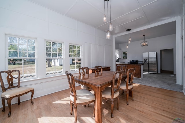 dining area featuring a wealth of natural light and light hardwood / wood-style floors