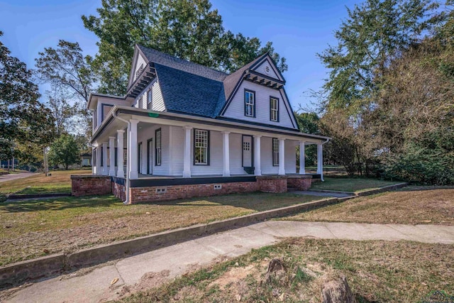 view of front of property with a porch and a front yard