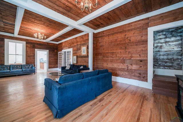 living room with wood ceiling, beam ceiling, and a chandelier