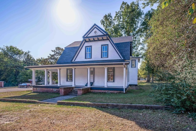 victorian home with a front lawn and a porch