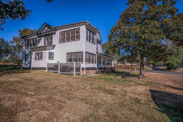 rear view of house with a lawn