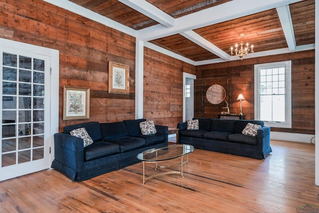 living room featuring beam ceiling, wood ceiling, and wooden walls