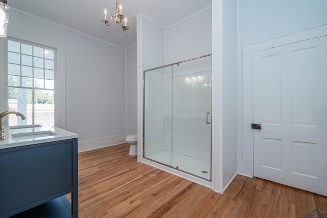 bathroom with walk in shower, vanity, a notable chandelier, wood-type flooring, and crown molding