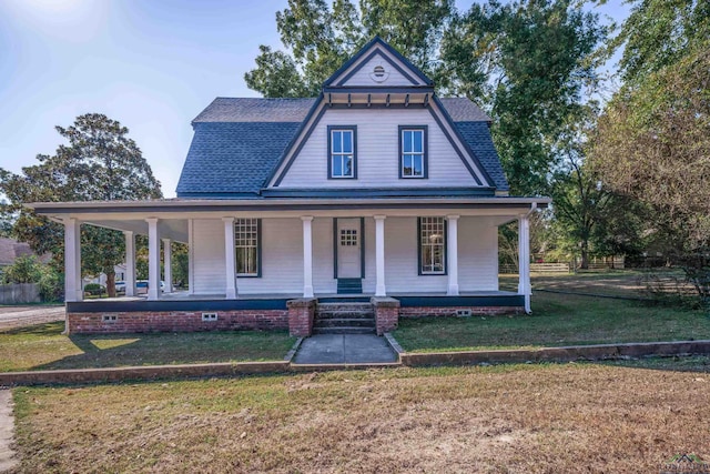 view of front facade with a front yard and a porch