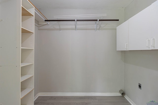 524 N College St, Lindale, TX 75771 - laundry room with electric dryer hookup, wood finished floors, and cabinet space