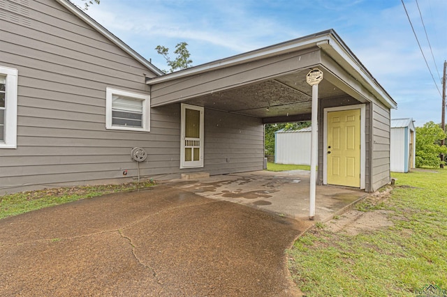 524 N College St, Lindale, TX 75771 - view of car parking with a carport, driveway, and a shed