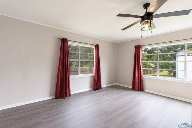 524 N College St, Lindale, TX 75771 - empty room with wood finished floors, ceiling fan, and ornamental molding