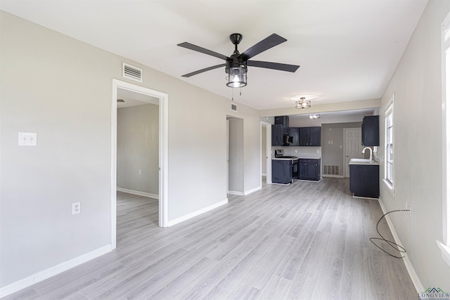524 N College St, Lindale, TX 75771 - unfurnished living room featuring a ceiling fan and light wood-type flooring