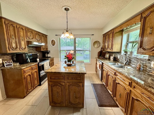 3201 Restview St, Longview, TX 75605 - kitchen featuring stainless steel appliances, a center island, a sink, under cabinet range hood, and backsplash