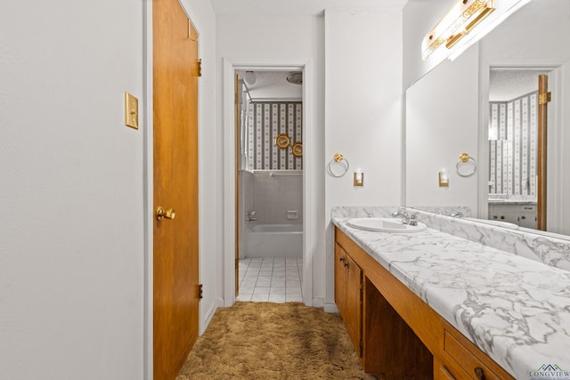 full bathroom featuring tile patterned floors, a textured ceiling, vanity, and baseboards
