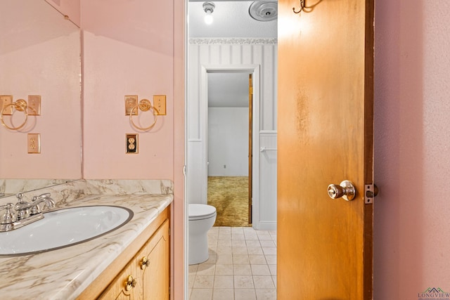 bathroom with tile patterned floors, toilet, and vanity