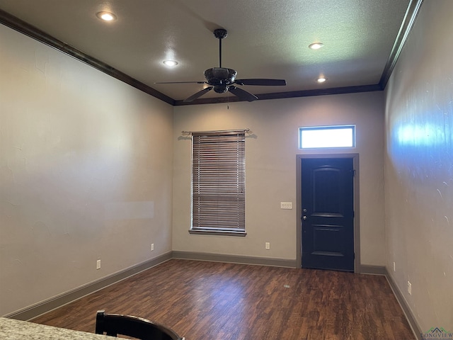 entrance foyer featuring dark hardwood / wood-style floors, ceiling fan, and crown molding