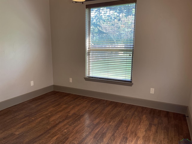 spare room with dark hardwood / wood-style flooring