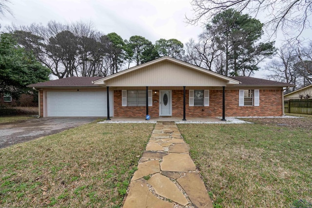 ranch-style house featuring driveway, a front yard, a garage, and brick siding