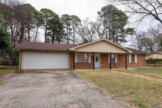 single story home featuring aphalt driveway, brick siding, covered porch, an attached garage, and fence