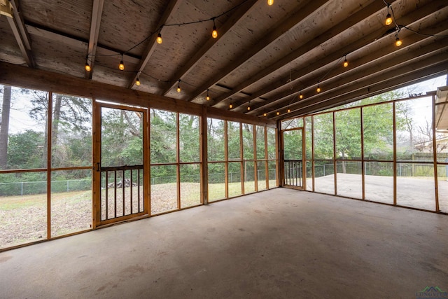 unfurnished sunroom featuring track lighting