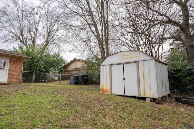 view of shed with fence and a gate