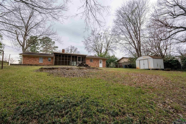 view of yard with a storage shed, an outbuilding, and a sunroom