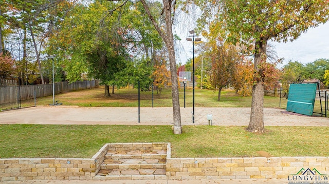 view of basketball court featuring a lawn