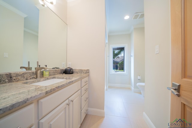 bathroom featuring tile patterned floors, crown molding, vanity, and toilet