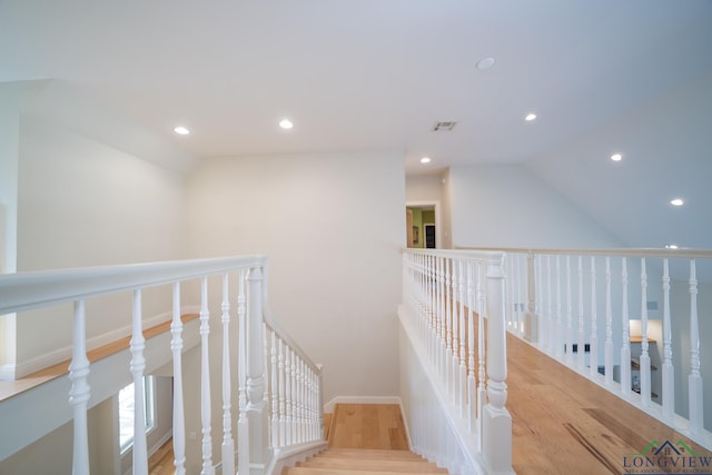 hallway featuring hardwood / wood-style floors and lofted ceiling