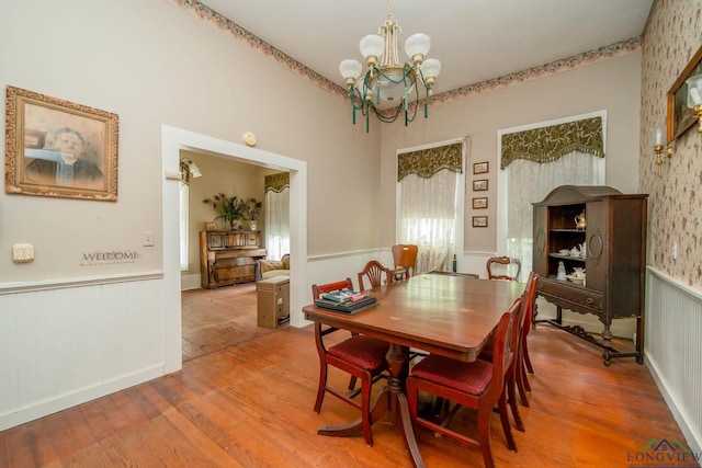 508 N Soda St, Jefferson, TX 75657 - dining room with a wainscoted wall, a chandelier, and wood finished floors
