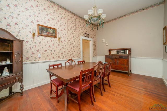 508 N Soda St, Jefferson, TX 75657 - dining room featuring a wainscoted wall, a chandelier, and wood finished floors