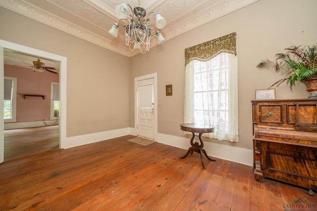 508 N Soda St, Jefferson, TX 75657 - entrance foyer with a chandelier, hardwood / wood-style floors, and baseboards