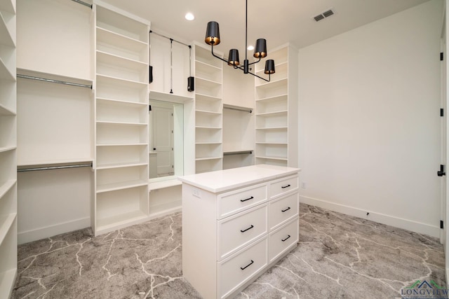 spacious closet with light carpet, a notable chandelier, and visible vents