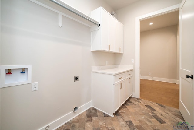 washroom featuring recessed lighting, hookup for a washing machine, baseboards, electric dryer hookup, and cabinet space