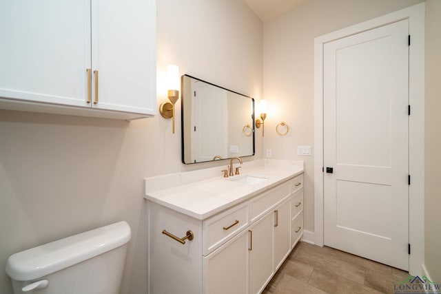 bathroom featuring toilet and vanity