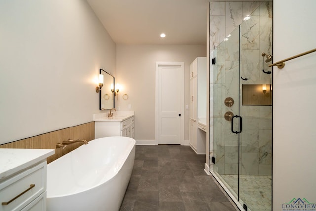 bathroom featuring a shower stall, a freestanding bath, vanity, and recessed lighting